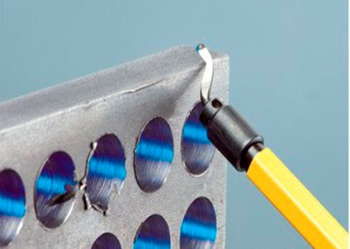 Illustrative manual deburring access around holes in a machined plate